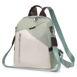 Green and white patchwork versatile backpack with adjustable straps on white background