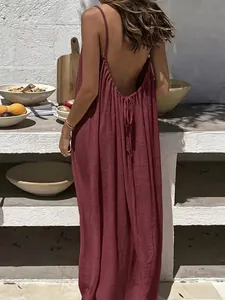 Rear view detail of an elegant backless maroon maxi dress with spaghetti straps
