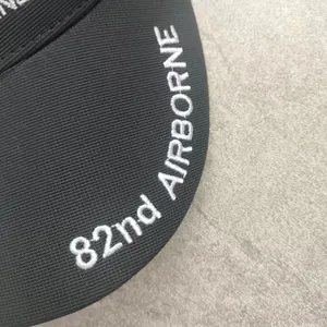 Close-up of 82nd AIRBORNE white embroidery on black twill baseball cap brim