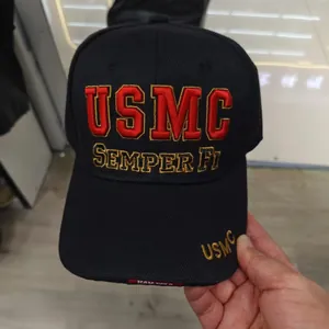 Detailed close-up of USMC embroidery on black cotton twill baseball cap with Semper Fi text