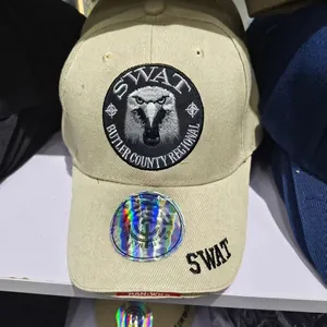 Detail of khaki tactical baseball cap featuring SWAT embroidery and laser security sticker