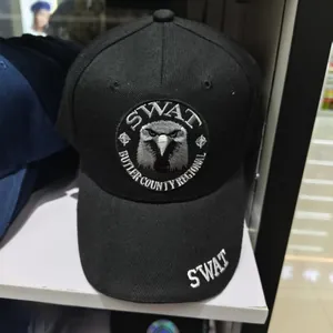 Close-up of black baseball cap featuring SWAT eagle embroidery and breathable fabric