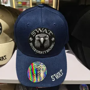Close-up of navy blue SWAT baseball cap with eagle embroidery and holographic sticker