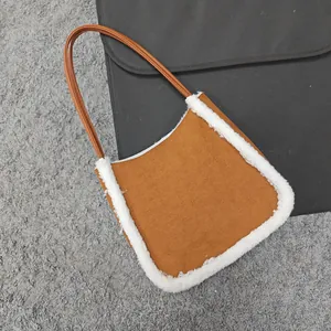 Detailed view of brown faux suede tote bag with plush white faux shearling trim accents