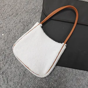 Close-up of white plush faux fur tote bag with brown leather shoulder straps