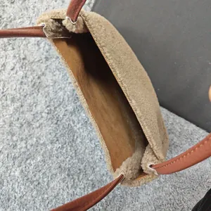 Top macro view of khaki faux fur tote bag showing spacious interior and brown leather handles