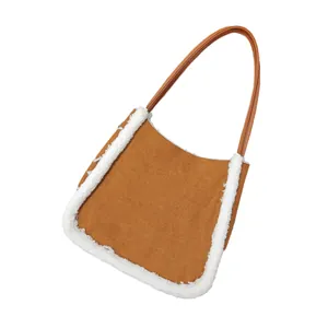 Brown faux suede shoulder bag with white sherpa trim and leather strap