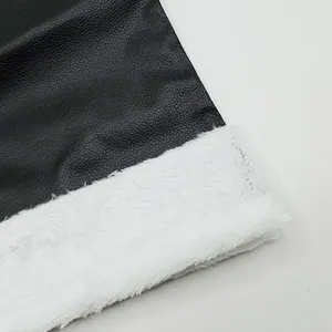 Close-up of black faux leather Santa boots with white plush faux fur trim detail.