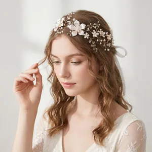 Close-up detail of a handmade bridal headpiece featuring white flowers and pearls