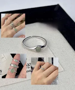 Detailed view of adjustable S925 silver ring featuring a pale green oval crystal