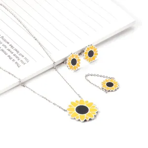 Detailed view of silver stainless steel sunflower jewelry set with yellow enamel daisy
