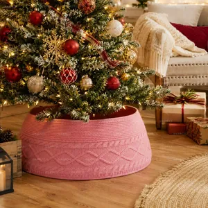 Cozy pink chunky knit Christmas tree collar featuring decorative diamond cable patterns
