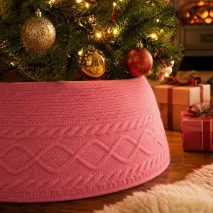 Pink cable knit Christmas tree collar with diamond patterns in a cozy holiday setting