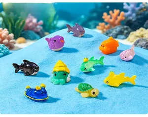 Mini resin sea animal figurines including shark turtle and octopus on blue sand