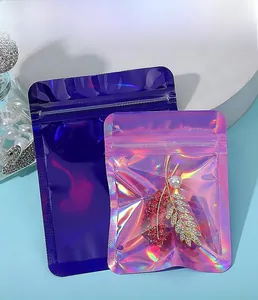 Detail view of holographic zip lock jewelry bags in pink and purple iridescent colors