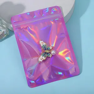 Macro shot of an enamel butterfly brooch displayed on a holographic iridescent zipper bag