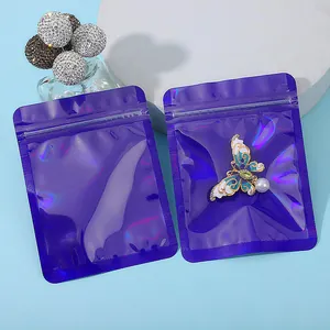 Detail of purple holographic resealable jewelry bag with butterfly brooch inside