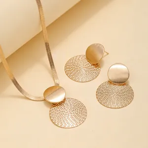 Elegant gold jewelry set with geometric pendants and textured flat snake chain