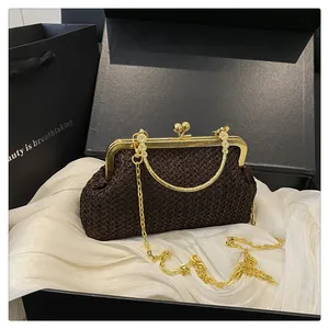 Brown woven shell bag with gold clasp and chain in premium gift packaging
