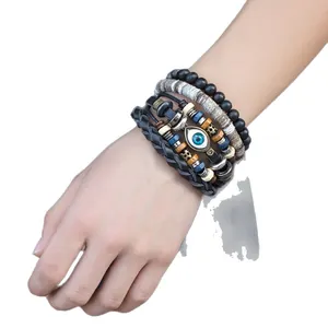 Ensemble de bracelets en cuir ethniques vintage avec œil bleu et tresses perlées complexes.