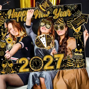 Group of women using 2027 New Year party photo booth props and decorative black gold frame
