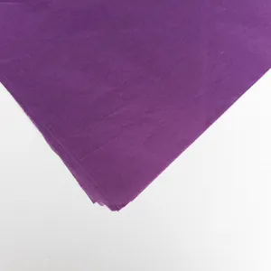 Close-up macro view of purple tissue paper showing fine texture and layered paper edges