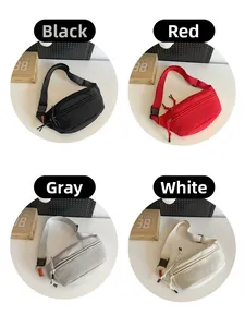 Dettaglio di borse a tracolla in tela nei colori nero, rosso, grigio e bianco con fibbie