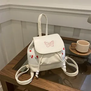 Mini white cherry backpack with pink butterfly embroidery and bead handle detail