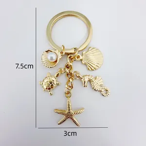 Marine ocean themed gold keychain with starfish turtle shells and dimension markings