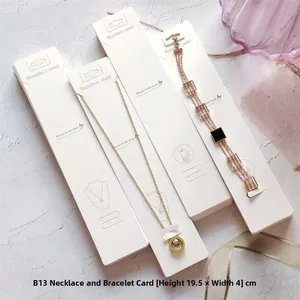 Detail showing white cardstock display cards for stainless steel jewelry, 19.5cm x 4cm