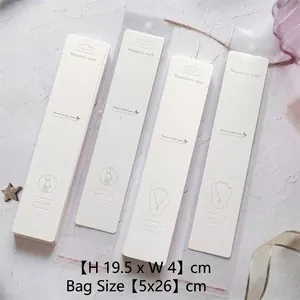 Macro detail of white B13 jewelry display cards with dimensions 19.5x4cm and clear bags