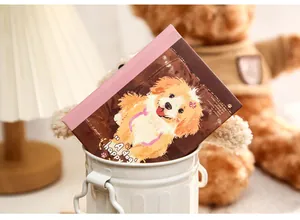 Detailed view of the cute puppy illustration on the cover of an A7 pocket notebook.