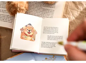 Close-up view of A7 illustrated diary notebook featuring cute puppy stickers and quotes