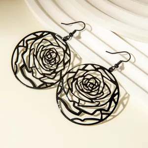 Detailed view of black rose pattern hollow earrings with intricate metalwork
