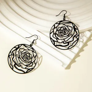 Detail of elegant black rose hollow-out circular drop earrings for women.