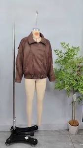 Detailed front view of brown oversized suede pilot jacket with waist belt design.