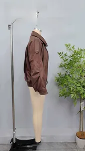 Side view of a brown faux suede bomber jacket on a mannequin, oversized fit detail