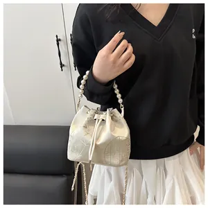 Elegant New Chinese style bucket bag with pearl handle and traditional embroidery patterns.