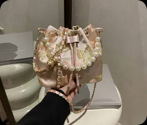 Detail view of New Chinese style bucket bag with pearl handle and floral embroidery