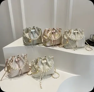 Collection of New Chinese style Qipao bucket bags with pearl handles and floral prints