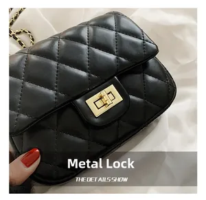 Detailed close-up of the elegant golden metal clasp on a black quilted chain bag