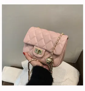 Detailed view of pink quilted leather bag with iconic golden ball chain adjustment buckle