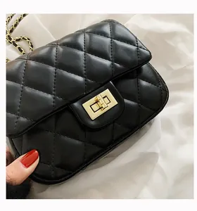 Close-up of black quilted leather bag with gold chain strap and square metal lock