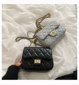 Detail of classic quilted flap bags with gold metal clasps and chain straps