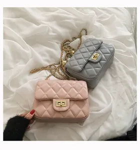 Detailed view of pink and grey quilted mini chain bags with gold twist locks