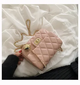 Detailed view of pink quilted handbag with gold sphere adjustment ball and chain strap
