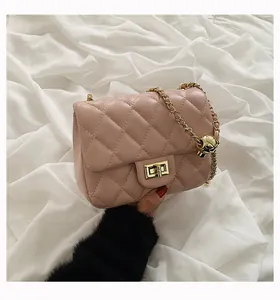 Detail of light pink quilted crossbody bag with adjustable golden ball chain strap