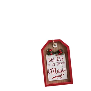 Vintage Christmas wooden door hanging with 'Believe in the Magic' text and red berries