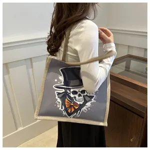 Lifestyle view of canvas tote bag featuring stylish cartoon skull illustration