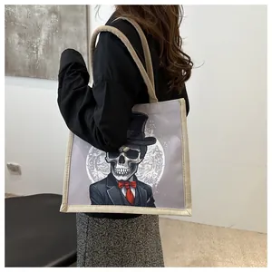 Detail of gothic skeleton print and durable hemp rope handles on canvas tote bag